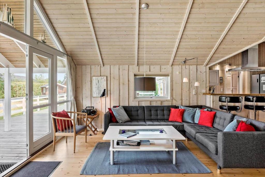 a living room with a couch and a table at 7323-Bogo-Vindrosen-23 in Gammelby