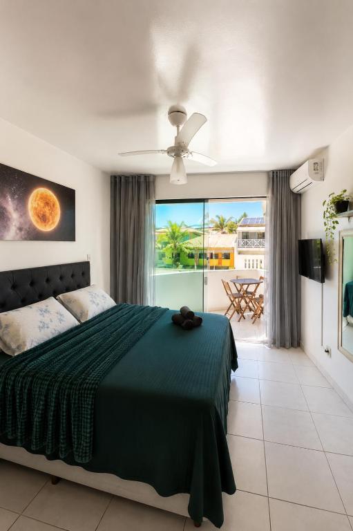 a bedroom with a bed and a view of the ocean at Casa Estelar in Cabo Frio