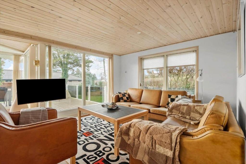 a living room with couches and a flat screen tv at R623-Rodvig-Laurasvej-13 in Rødvig