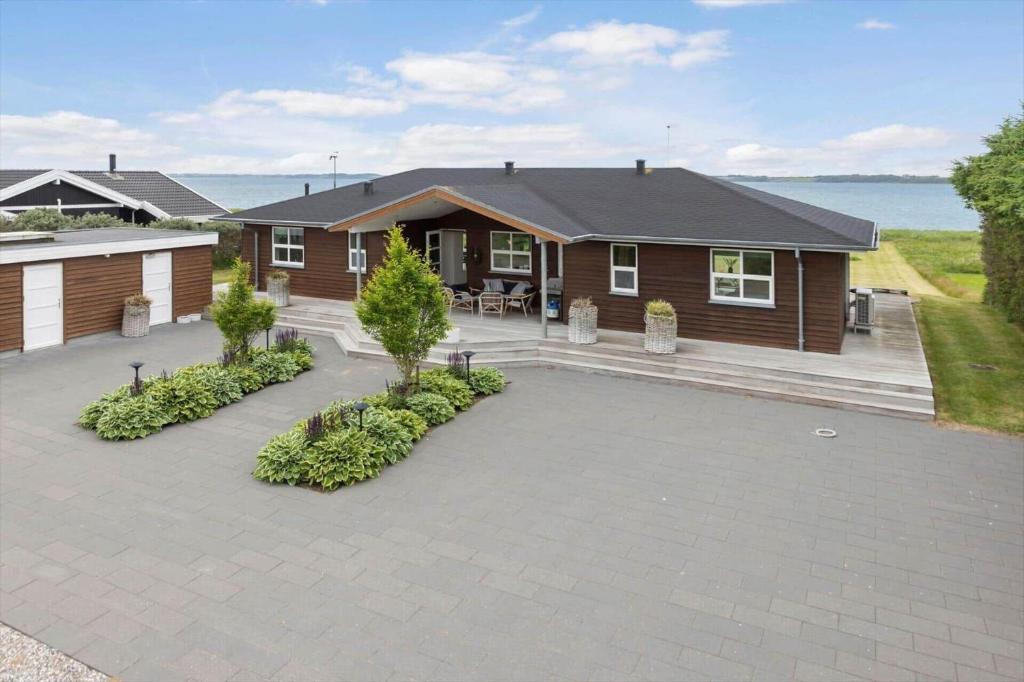 a house with a patio in front of it at LF15163-Hojslev-Jelsevej-163 in Lundø