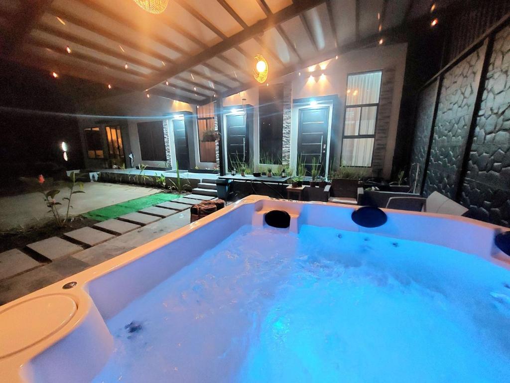 a jacuzzi tub in the middle of a house at River Suite at Luna Negra Suites & Spa in El Castillo de La Fortuna