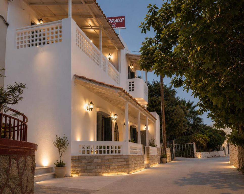 a white building with lights on the side of it at Semiramis Hotel in Adamantas