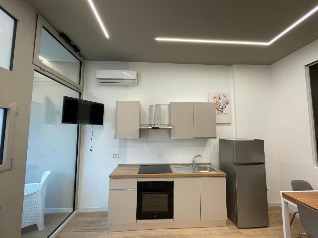 a kitchen with a sink and a refrigerator at Solea Home in Termoli