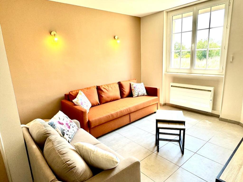 a living room with a couch and a table at La Rivière Enchantée in Peyraud
