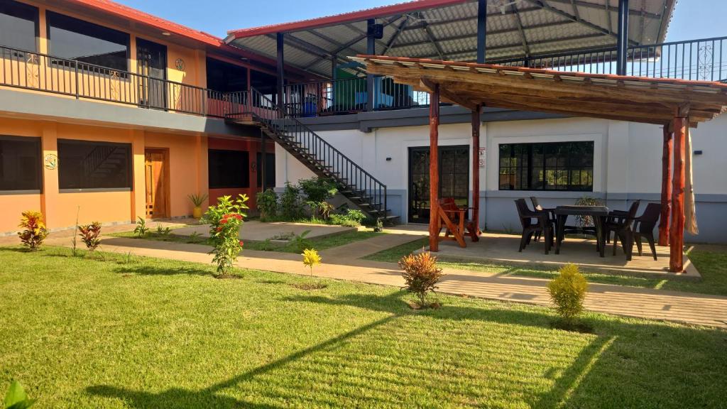a house with a table and chairs in a yard at mi casa tropical in Hacienda Santa Clara
