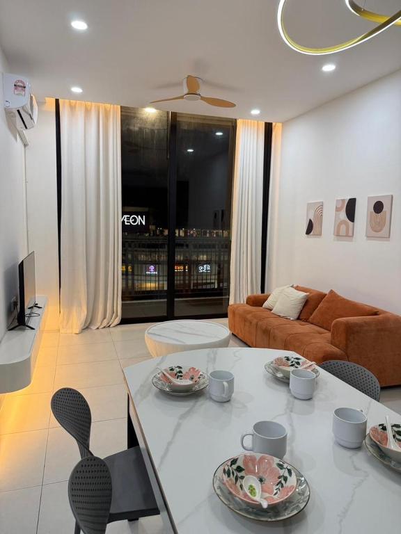 a living room with a table and a couch at Podium aparment in Kuching