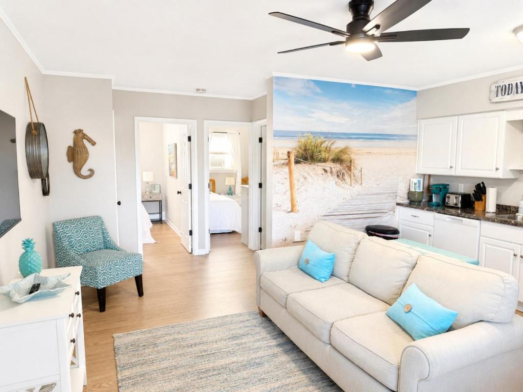 a living room with a white couch and a kitchen at Between Tides 2BR Walk to Beach Unit B in Seaside Park