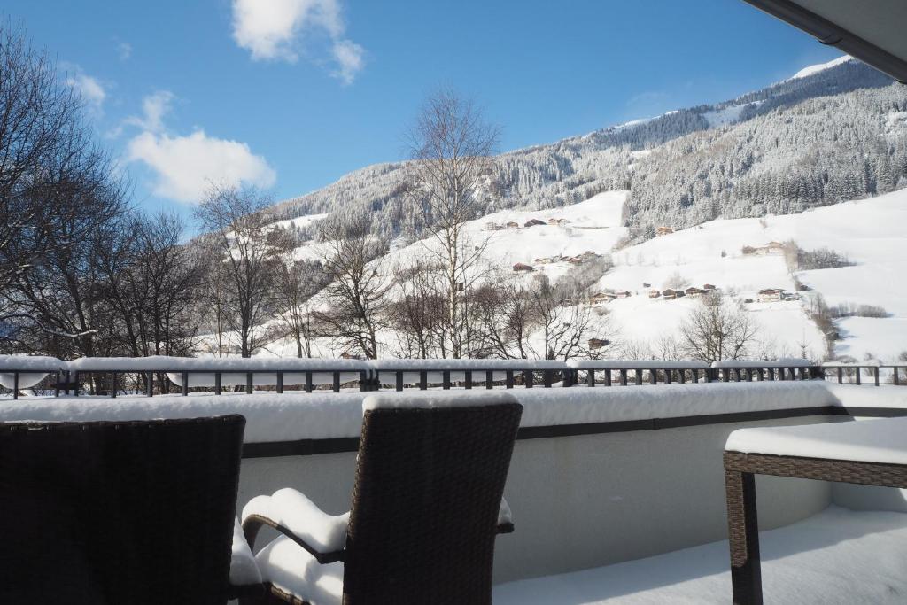 a view of a snow covered mountain from a balcony at Apartment Smaragdblick Wildkogel in Bramberg am Wildkogel