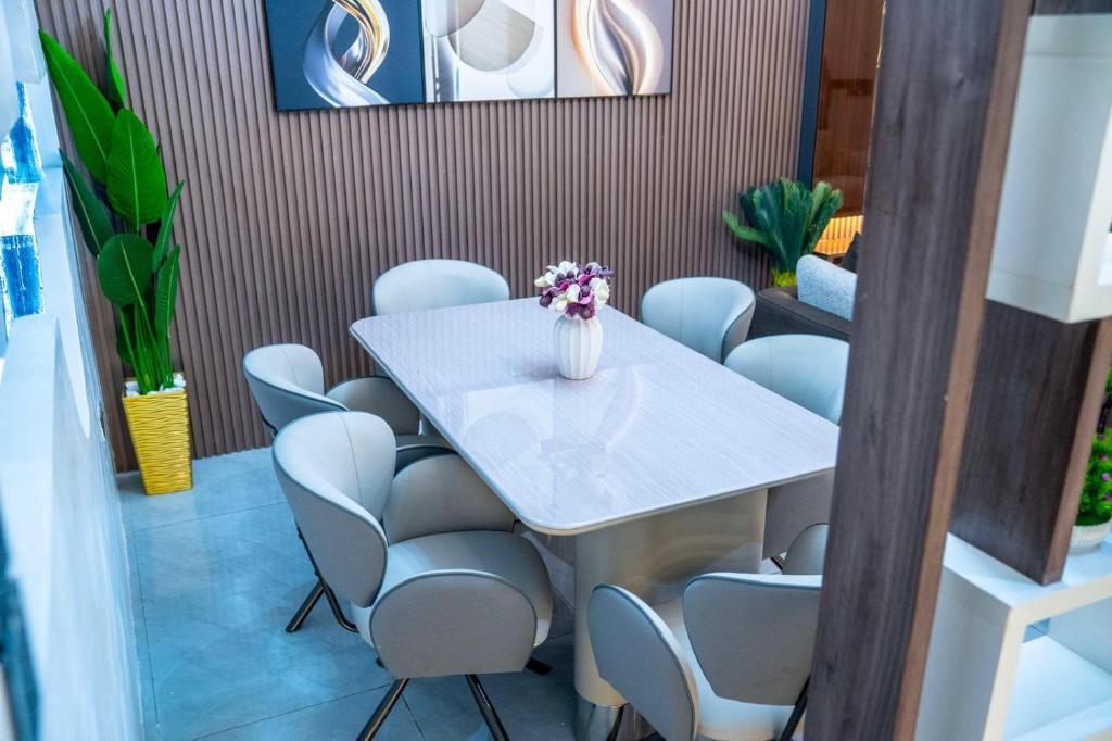 a meeting room with a table and chairs at CozyKeys luxurious Apartment in Abuja