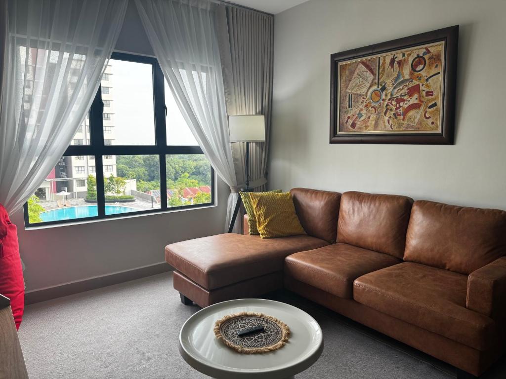 a living room with a couch and a table at Rumah Suri Homestay at Arena2 Residence Kota Warisan in Sepang