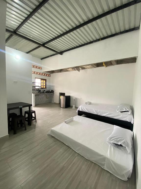 a room with two beds and a table in it at Ambar Apartahotel - Clasico in San Luis
