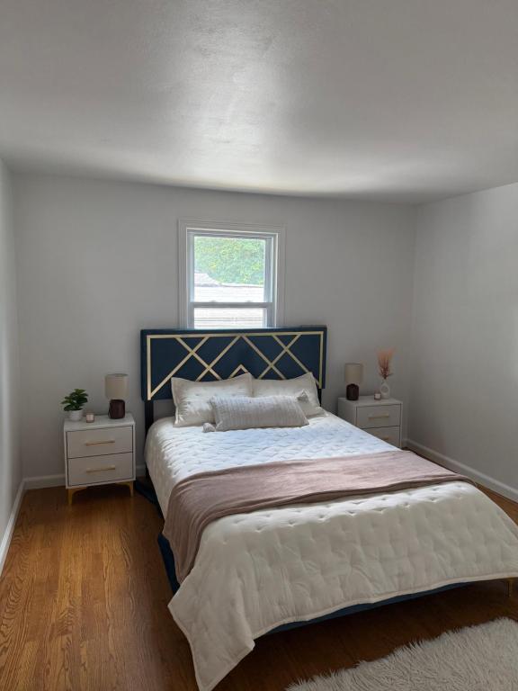 a bedroom with a large bed and a window at Boho room in house in New Haven
