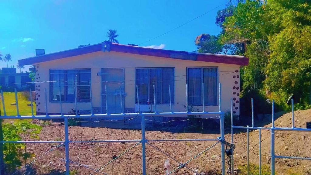 a house under construction behind a fence at Nasau Holiday Apartment in Sigatoka