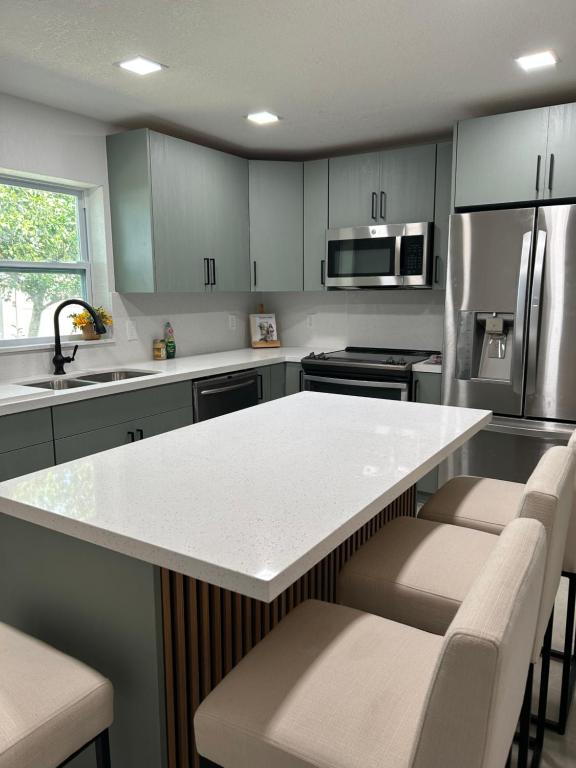 a kitchen with a white counter top and appliances at cozy bohemian in North Miami