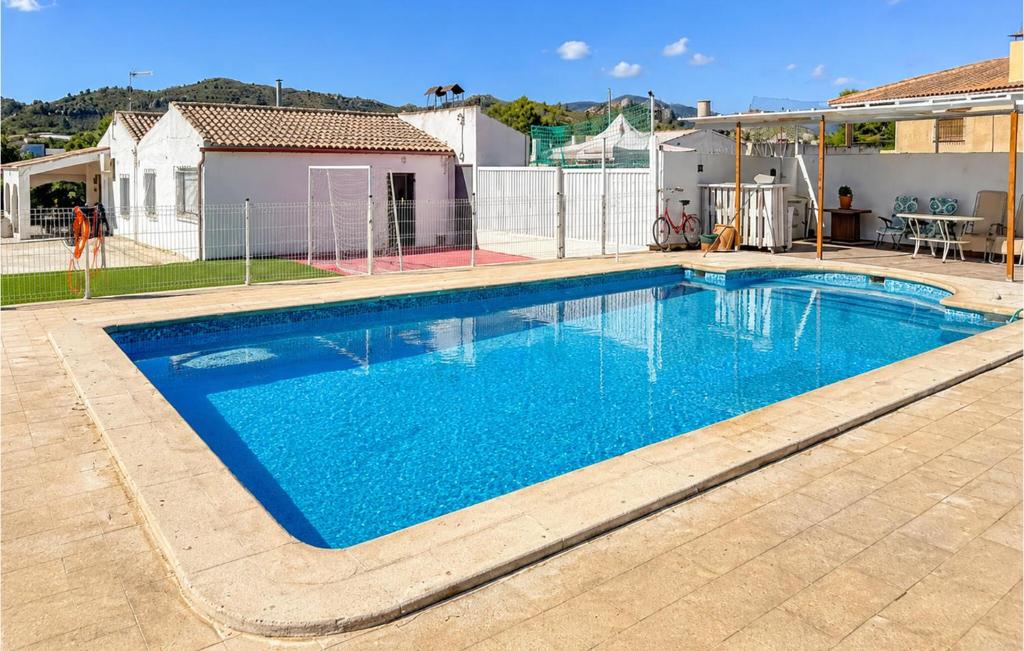 a large blue swimming pool in a yard at Awesome Home In Abarán in Abarán
