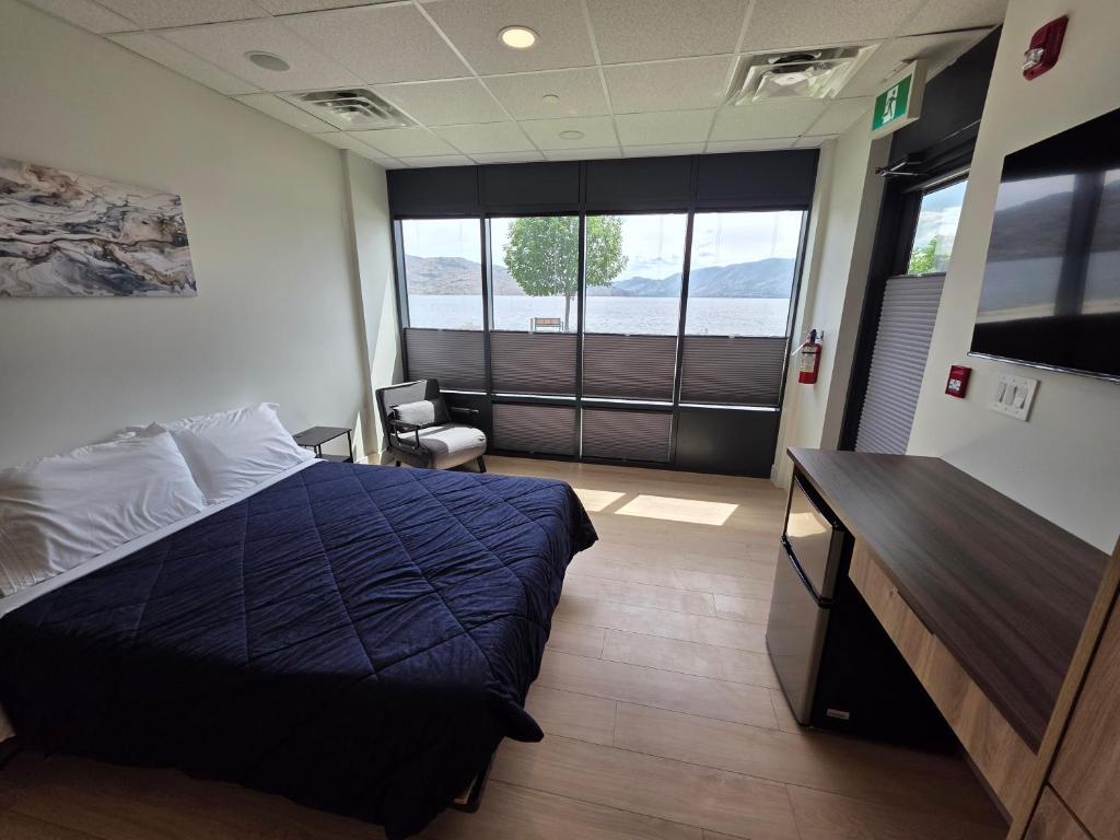 a bedroom with a bed and a desk in a room at PeachView Studio 103 in Peachland