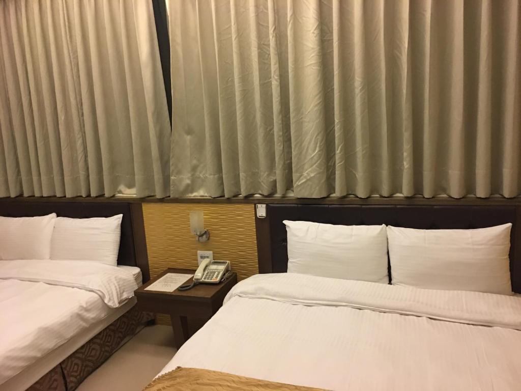 Postel nebo postele na pokoji v ubytování Ri Yue Hu Pan Resort