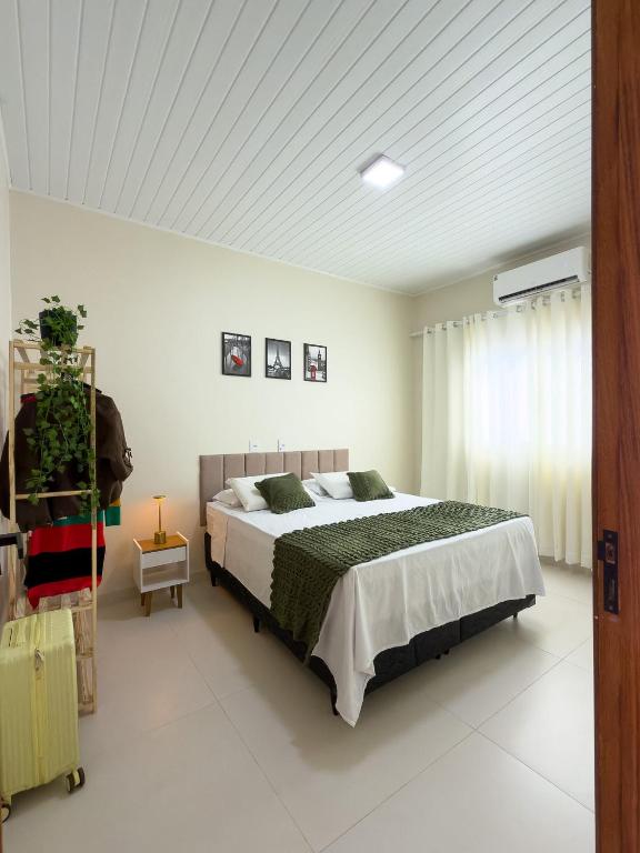 a bedroom with a large bed in a room at Casa 01 - Completa e moderna 5 minutos do centro in Alta Floresta