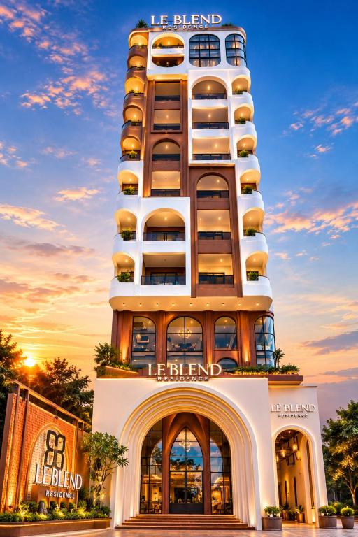 a tall building with a hotel in front of it at Lé Blend Residence in Krong Poi Pet