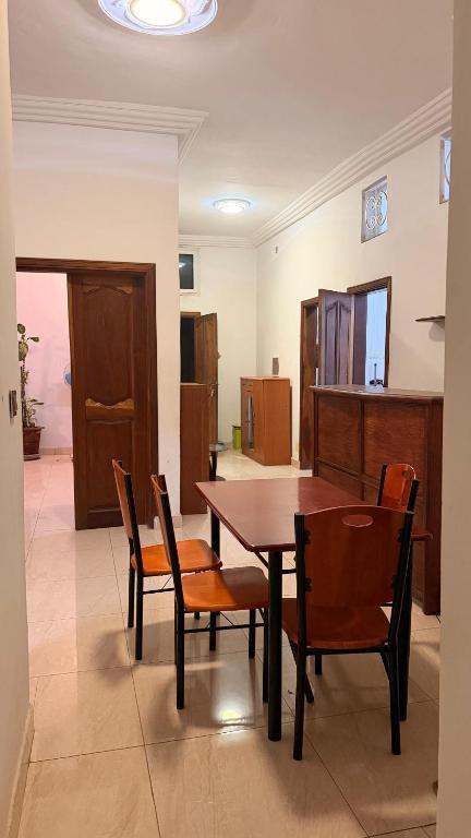 a dining room with a wooden table and chairs at Adelhouse in Saint-Louis