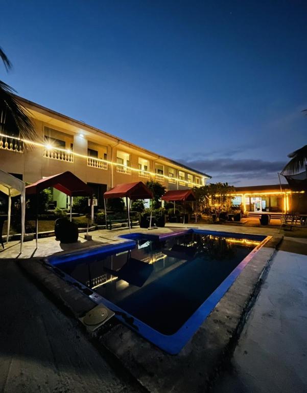 a swimming pool in front of a building at night at Nadi Fancy Hotel in Nadi