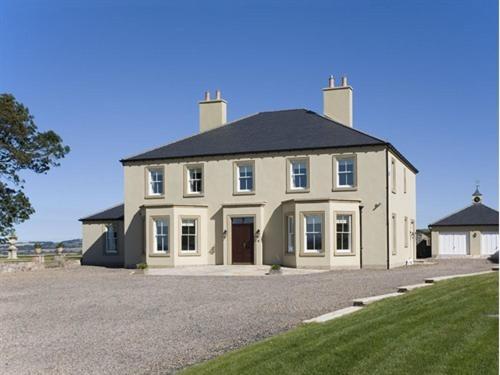 a large white house with a black roof at West Longridge Manor B&B in Berwick-Upon-Tweed