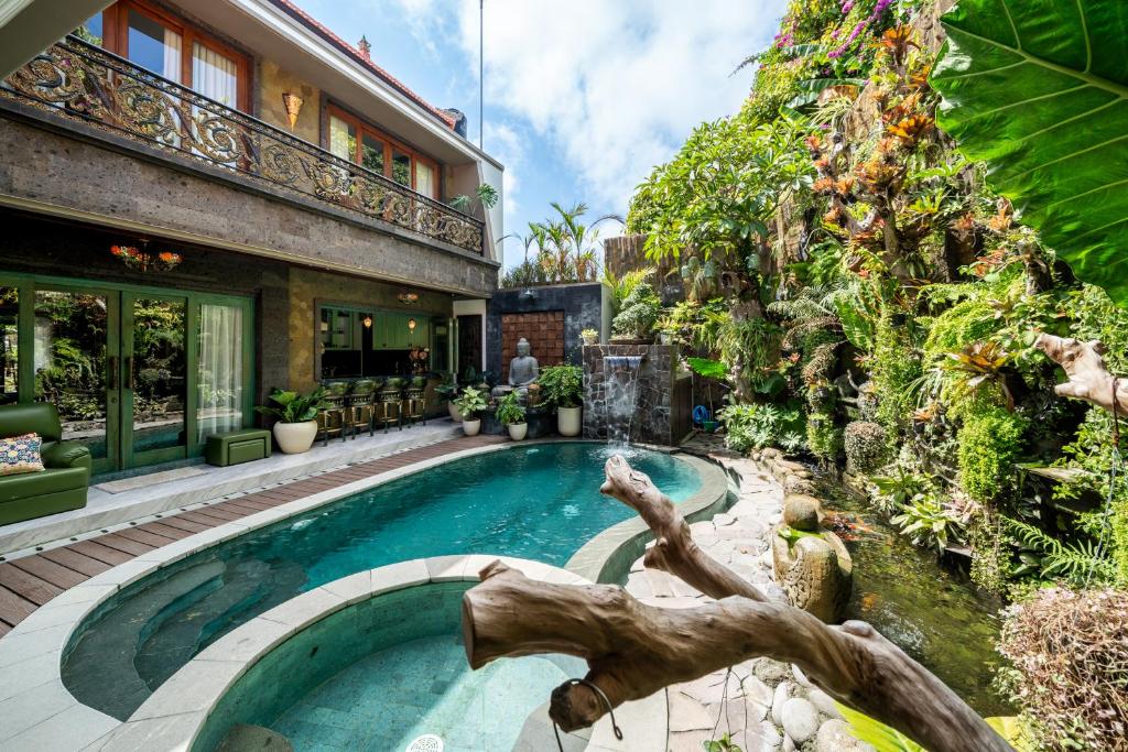 a house with a swimming pool in a yard at Puri Mayapada Nusa Dua Bali in Nusa Dua