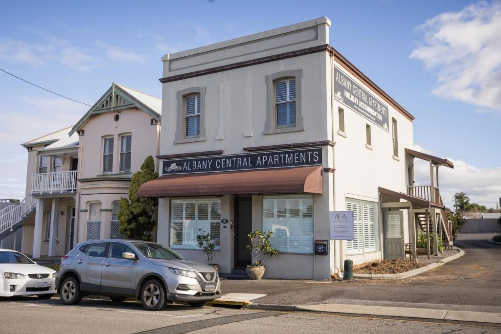 a building with a car parked in front of it at Albany Central Apartments in Albany