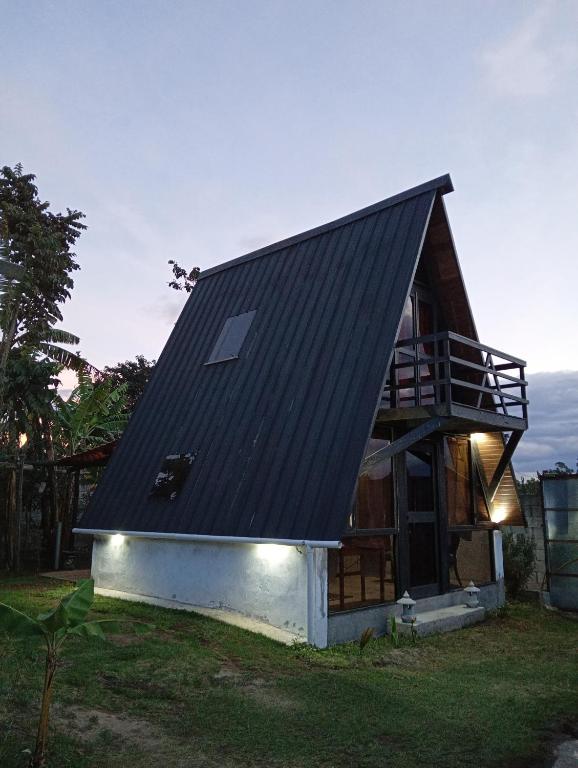 a small house with a black roof on top at Casa paula in San Agustín