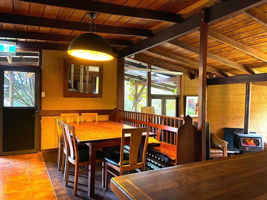 a dining room with a wooden table and chairs at Eucalyptus House in Pemberton