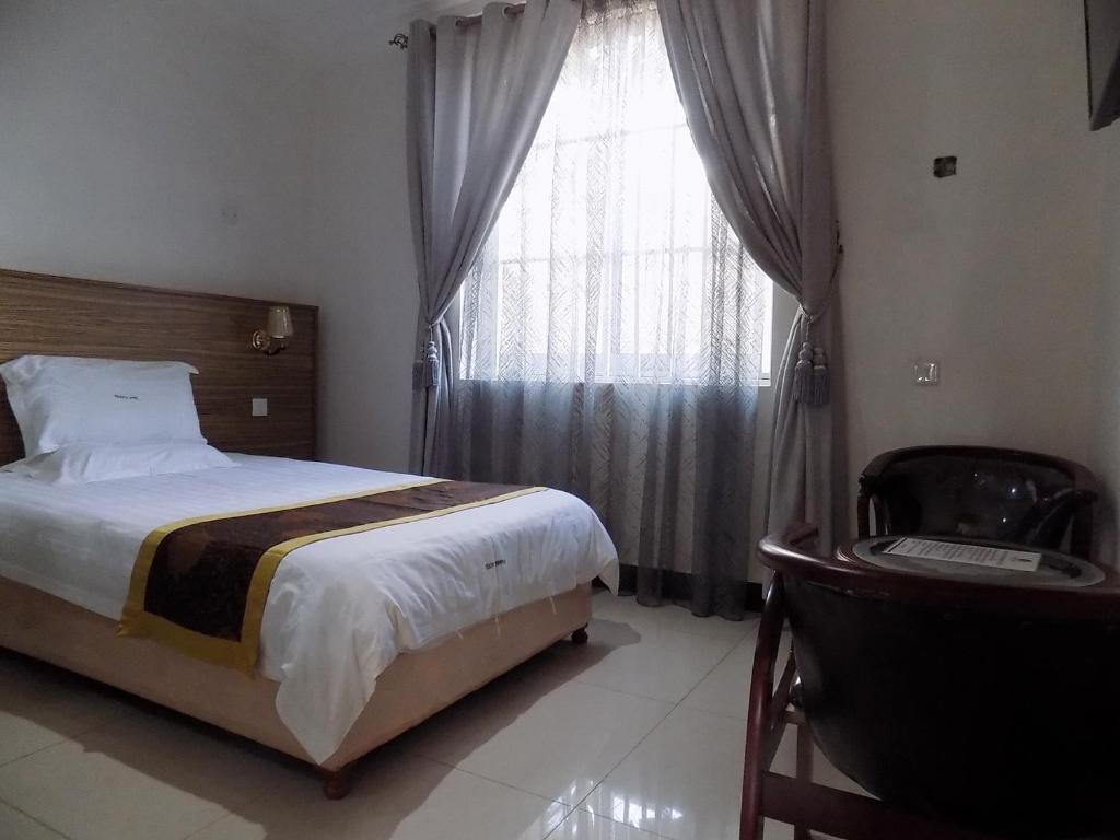 Postel nebo postele na pokoji v ubytování Remmings Hotel Kampala