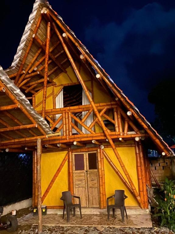 a house with chairs in front of it at night at La aldea in Capurganá