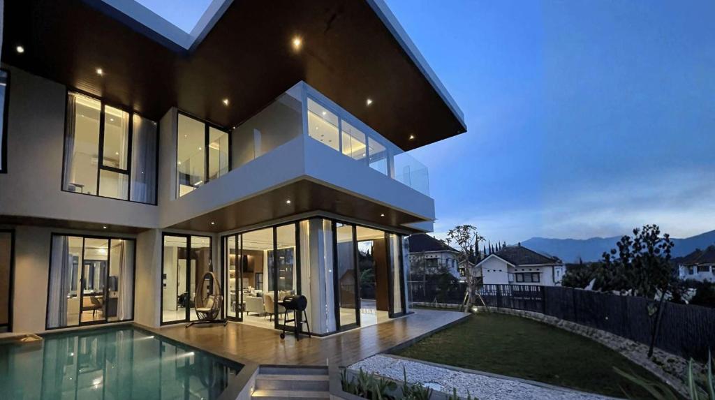 a large house with a pool in front of it at Alcola Boutique Villa - Caspia Unit in Tlekung