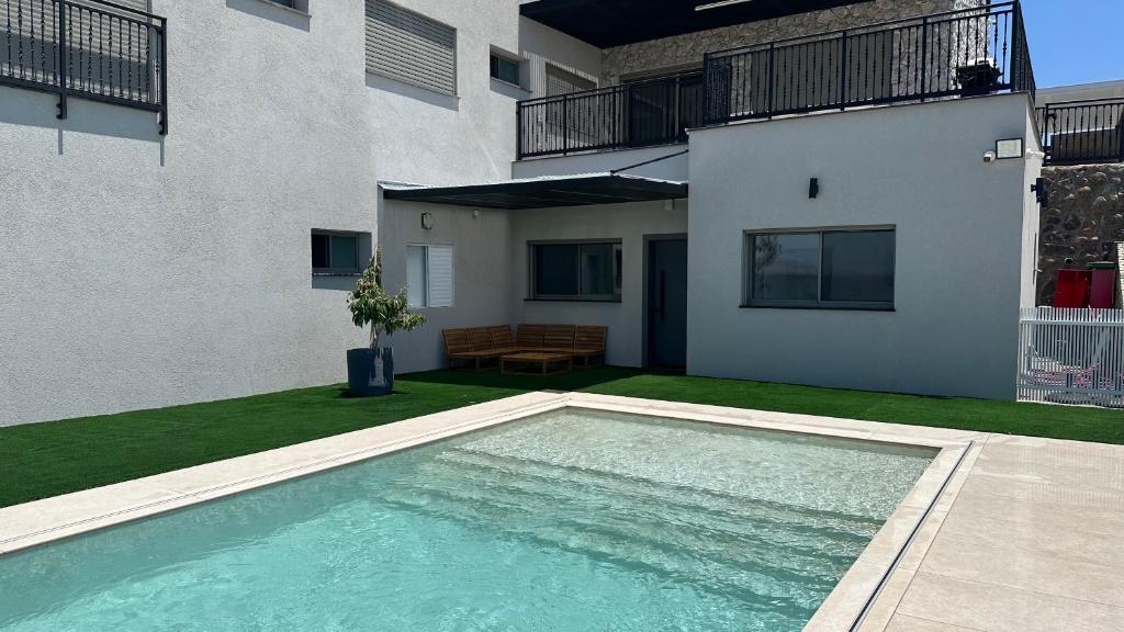 a swimming pool in front of a building at Private Pool Retreat for Two - Golan in Qasrîne