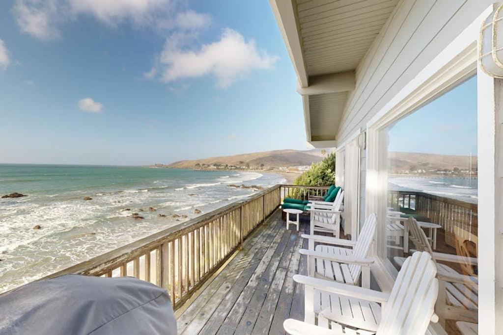 a porch with chairs and the ocean on a beach at Oceanfront Dream in Cayucos