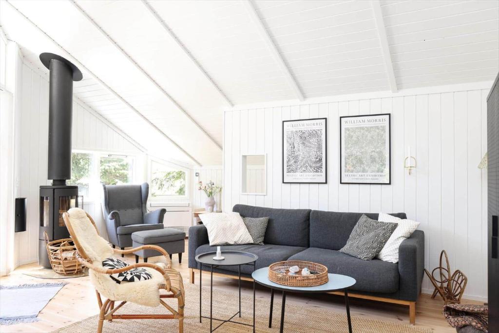 a living room with a couch and a fireplace at 13376-Asnaes-Dommergardsvej-18 in Asnæs