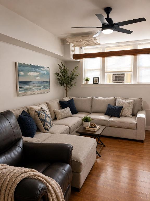 a living room with a couch and a ceiling fan at 8 minutes from 2026 FIFA World Cup Final! in Rutherford