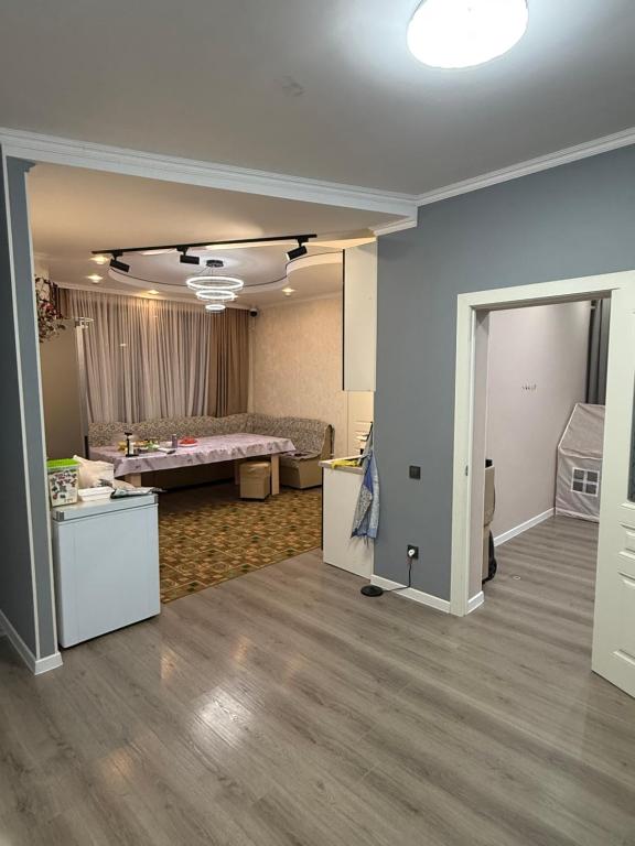 an empty room with a bedroom and a living room at Гостевой дом БАЯН in Cholpon-Ata