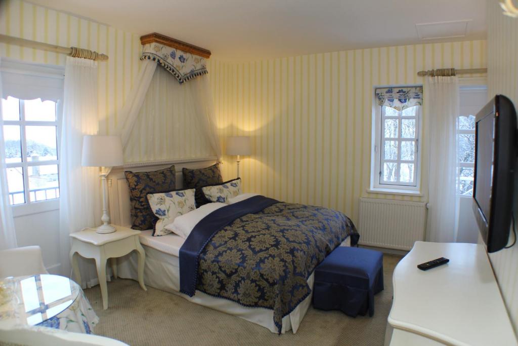 Postel nebo postele na pokoji v ubytování Vraa Slotshotel