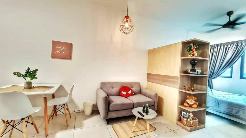 a living room with a chair and a table at 38 Romantic Studio Meritus Prai in Perai