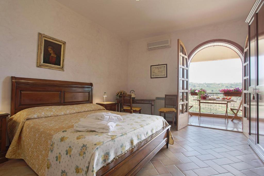 a bedroom with a bed and a large window at Villa Diana in Agrigento