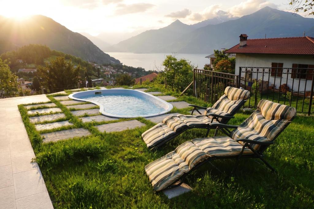 a group of chairs sitting in the grass near a pool at Clubhouse in Menaggio