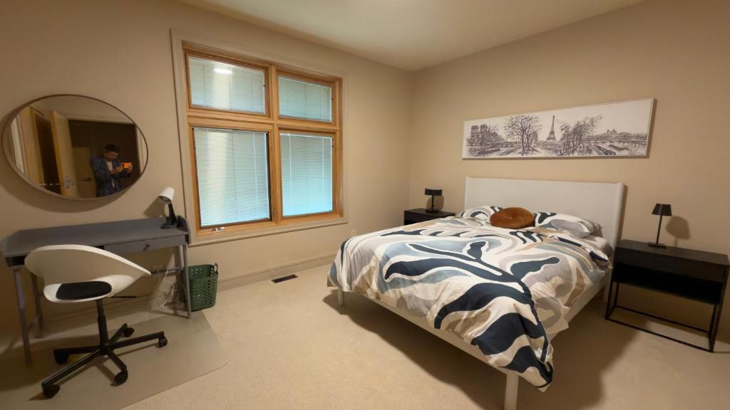 a bedroom with a bed and a desk and a mirror at Test Villa in Victoria
