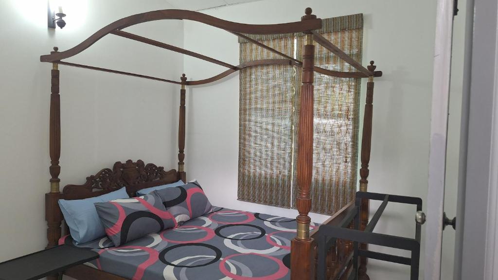a bed in a bedroom with a canopy bed at Vacation Villa - Katunayake in Kotugoda
