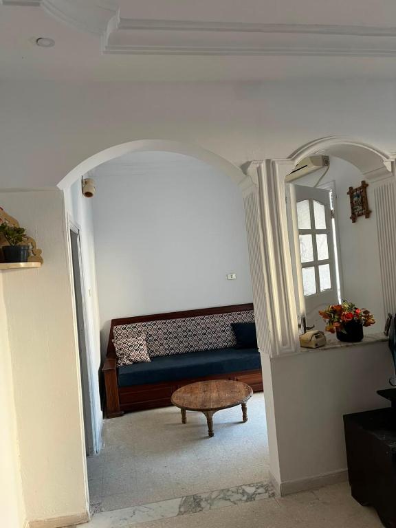 a room with a bed and a table in it at Dar nawara in Kelibia