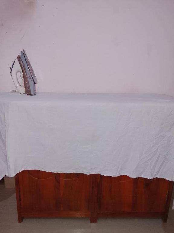 a bed with a white sheet on top of it at TRAVAL dksr in Anuradhapura