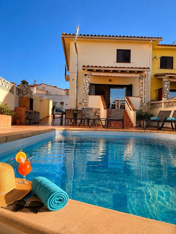 a swimming pool in front of a house at CASA PUIG, Piscina Privada ,Aire Acondicionado Free in L'Escala