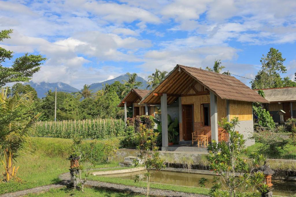a house in the middle of a field at Bee Camp Bedugul by AGATA in Bedugul
