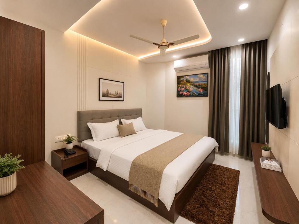 a hotel room with a bed and a television at Hotel RajKailash in Jaipur
