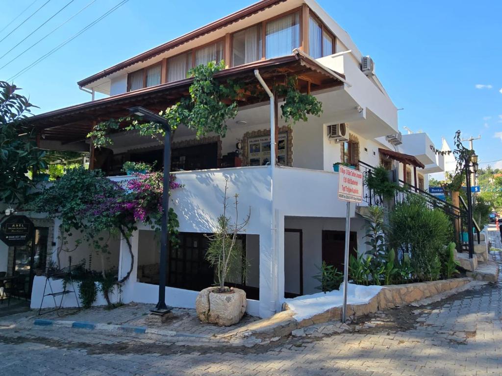 a building with plants on the side of it at Golden Pension in Patara